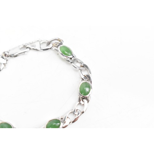 251 - An 18ct white gold jade set bracelet, having curb chain links with five jade cabochons, certificate ... 