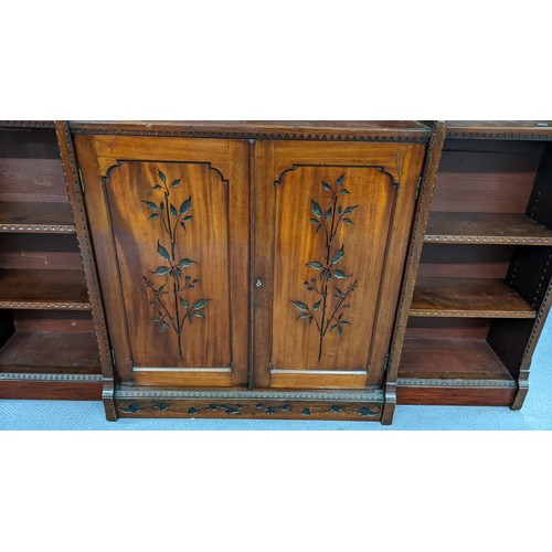 250 - A late Victorian Aesthetic mahogany open breakfront bookcase, having a moulded cornice, loose shelve... 