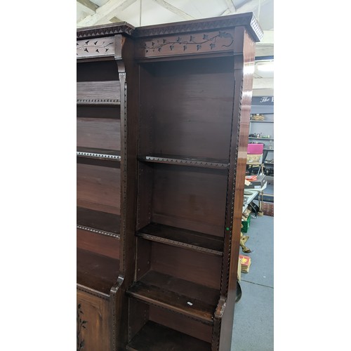 250 - A late Victorian Aesthetic mahogany open breakfront bookcase, having a moulded cornice, loose shelve... 