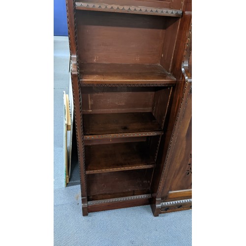 250 - A late Victorian Aesthetic mahogany open breakfront bookcase, having a moulded cornice, loose shelve... 