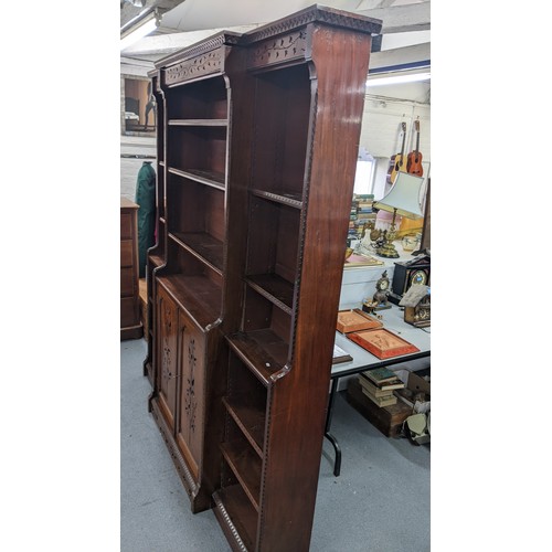 250 - A late Victorian Aesthetic mahogany open breakfront bookcase, having a moulded cornice, loose shelve... 