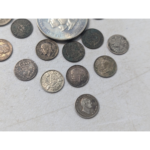 28 - A mixed collection of British coins to include an 1836 William IV fourpence, along with mixed Victor... 