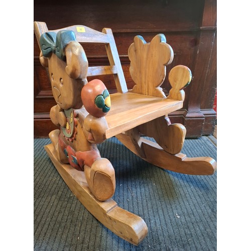 55 - A modern teak child's rocking chair with baby teddy bear design to the sides. Location:G