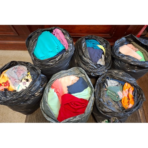 61 - Six large bags of dressmakers material comprising 4 bags of plain and 2 bags of printed fabric, leng... 