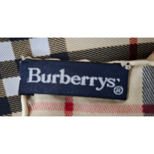 18 - Burberrys- A silk scarf in brown and gold tones together with branded scarf slip wallet. Location:R1... 