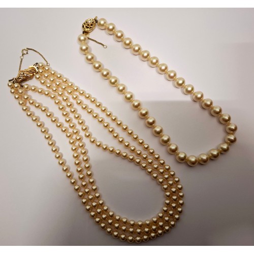 59 - A Majolica simulated 3-strand pearl necklace with silver gilt clasp stamped 925 with 3 inset crystal... 