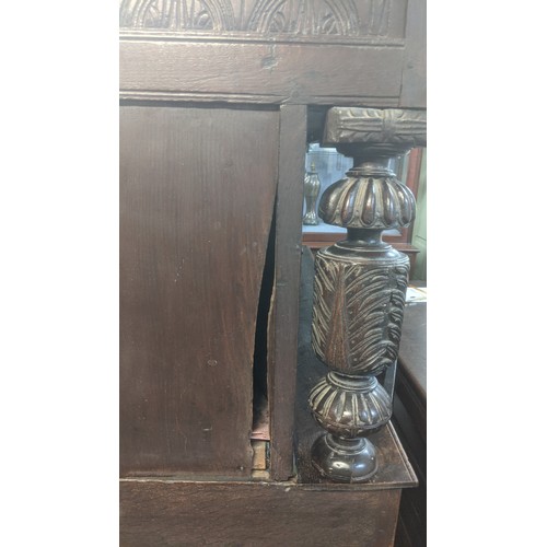 247 - A late 17th/early 18th century oak carved didarn / court cupboard, carved with repeating motifs, two... 