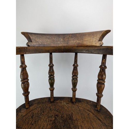 301 - An early 20th century beech and elm smokers bow chair, with a spindle back and turned legs

Location... 