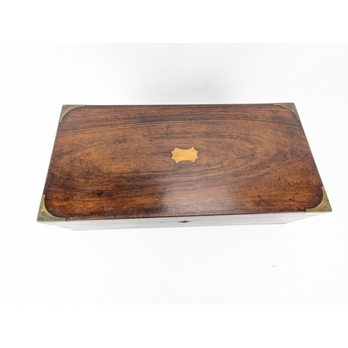 306 - A Victorian mahogany writing slope with brass banding and corners, enclosing a fitted interior and w... 