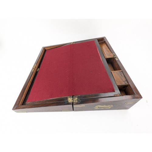 306 - A Victorian mahogany writing slope with brass banding and corners, enclosing a fitted interior and w... 