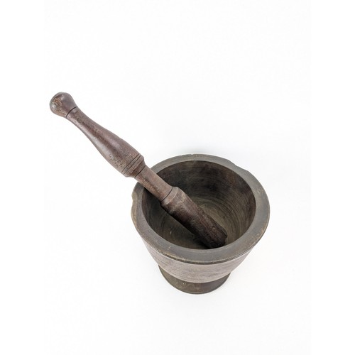 311 - A mid 20th century large hardwood pestle and mortar, on a flared foot, 33cm h, 35cm dia

Location:LA... 