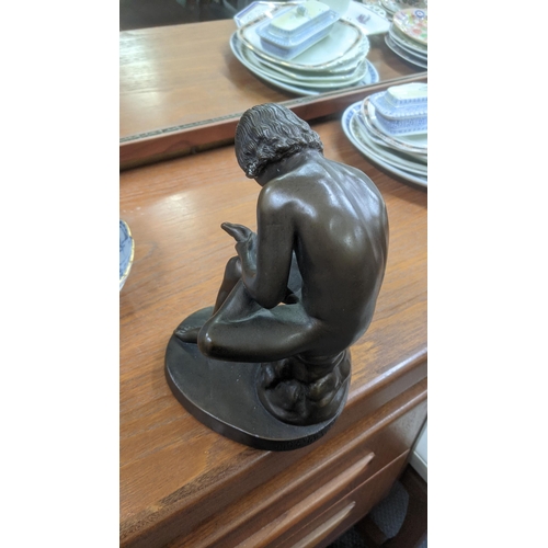 326 - A Bronze painted Grand Tour style sculpture fashioned as a seated boy assigned Austin prod to the ba... 