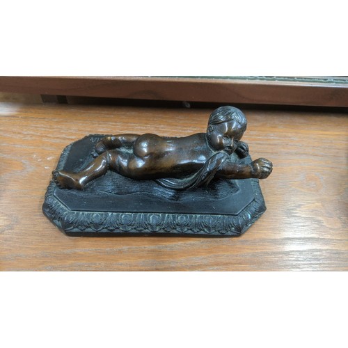 326 - A Bronze painted Grand Tour style sculpture fashioned as a seated boy assigned Austin prod to the ba... 