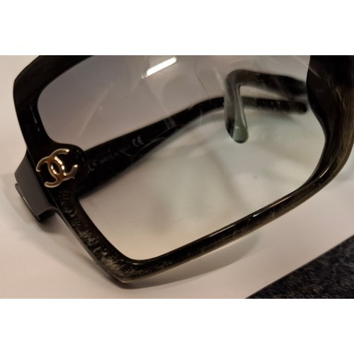 27 - Chanel- A pair of black oversized sunglasses A/F, model:5083 with branded case and box. Location:R2.... 