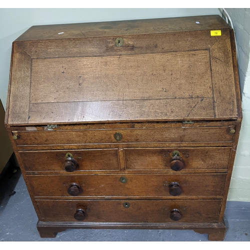 70 - A George III oak bureau, fall flap revealing a pigeonhole and drawer interior, with slide and secret... 