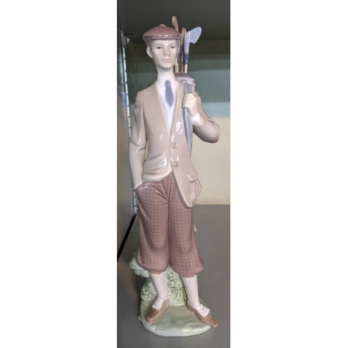 329 - A porcelain Lladro figurine of a golfer, titled Waiting to tee off from 1985, 29cm
Location 5.2
If t... 