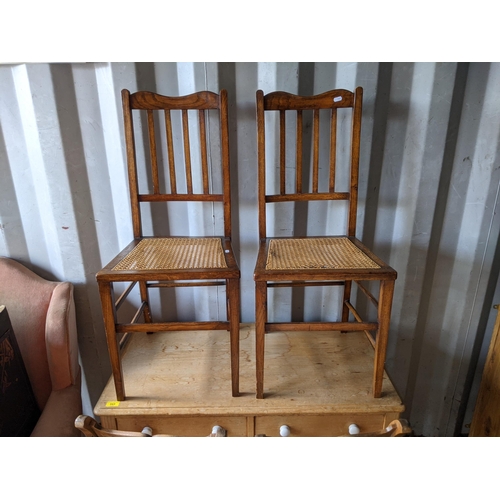 343 - A small pine table with two drawers raised on turned tapered legs along with a pair of light oak din... 