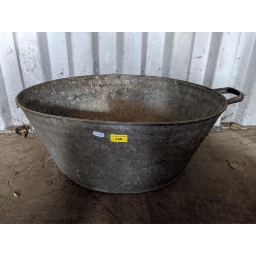 348 - A galvanised tub along with three graduating galvanised buckets all with swing handles and a galvani... 