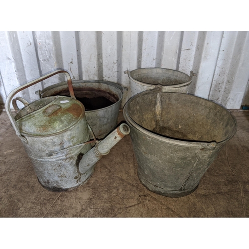 348 - A galvanised tub along with three graduating galvanised buckets all with swing handles and a galvani... 