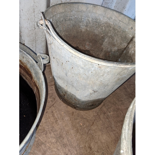 348 - A galvanised tub along with three graduating galvanised buckets all with swing handles and a galvani... 