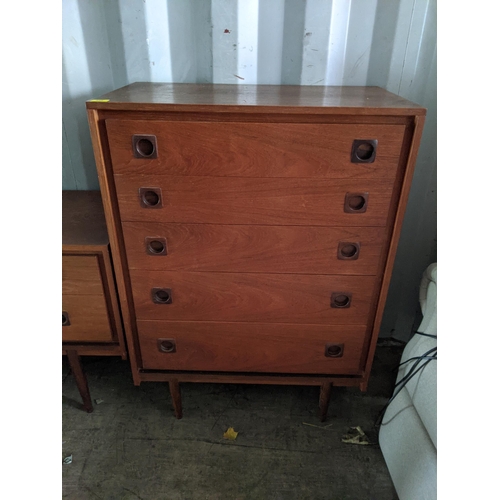 350 - A Wrighton teak chest of drawers with sculpted square handles, five graduating drawers raised on tap... 