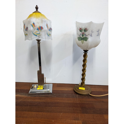 54 - An Art Deco chrome table lamp with inscription and a brass table lamp, each with floral decorated gl... 