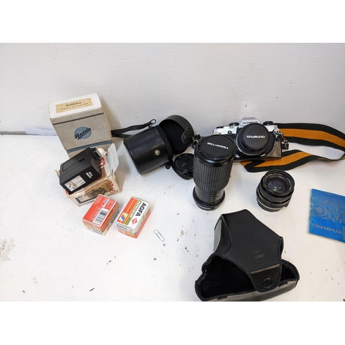 58 - Photographic equipment to include an Olympus OM10, Bell & Howell 80-205 and a Hoya 52mm lens
Locatio... 