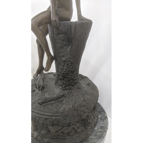 353 - A bronze sculpture of a nude woman resting on a tree stump, on a figural and floral base, titled 'Er... 