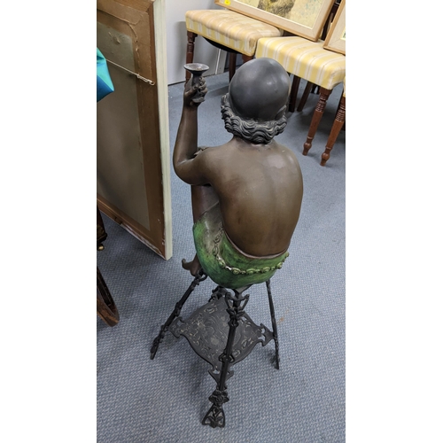 354 - A bronze Art Deco lamp base fashioned as a scantily clad woman resting on a cast iron stool, approx ... 