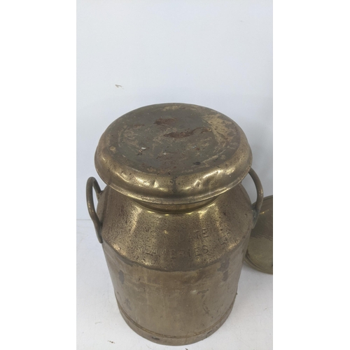 373 - A vintage brass milk churn stamped Igate Creameries Ltd 14651 Y, 51cm high, together with a brass be... 