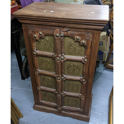 399 - An Indian teak carved Almirah cabinet having two panelled doors and fitted with shelves, 100.5cm h x... 