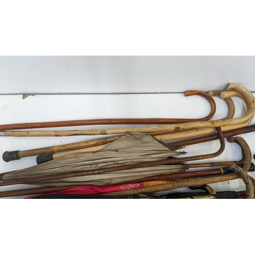 415 - A collection of walking sticks and umbrellas together with a District Railway Map of London
Location... 