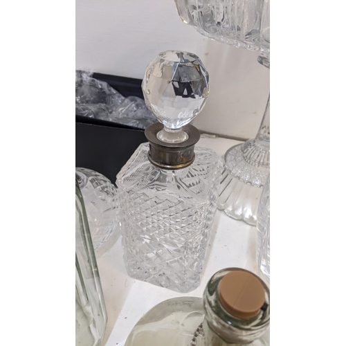 422 - A collection of glassware to include a crystal cut decanter with a silver crown, an inkwell with a s... 