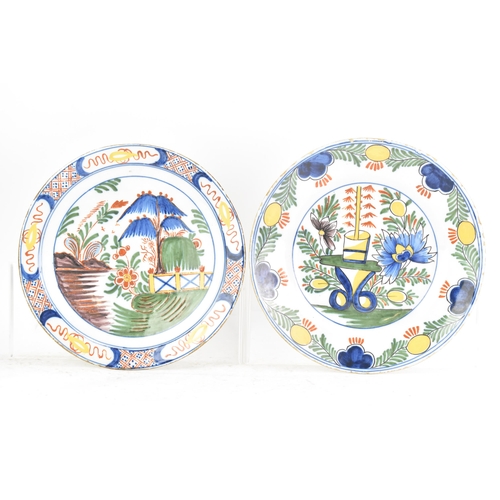 525 - Two 18th century Dutch Delft polychrome plates, one depicting a still life of flowers and a table in... 