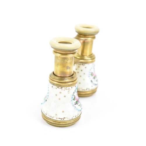 471 - A pair of late 19th century French gilt metal and porcelain opera glasses, painted with four floral ... 