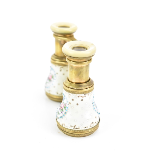 471 - A pair of late 19th century French gilt metal and porcelain opera glasses, painted with four floral ... 