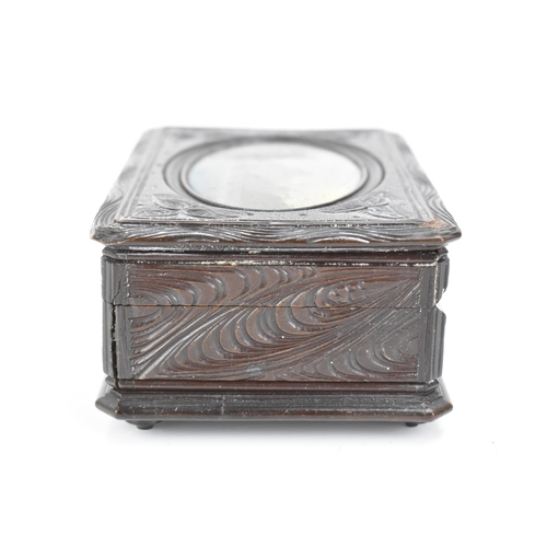 481 - A late 19th century black forest carved music box, the lid inset with an oval oil painting depicting... 