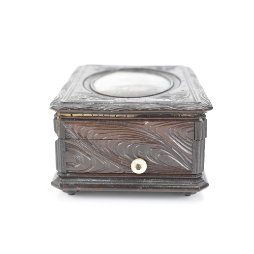 481 - A late 19th century black forest carved music box, the lid inset with an oval oil painting depicting... 