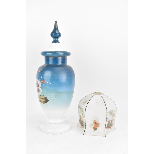 491 - A late 19th century opaline glass lidded vase, having a knopped finial, the ovoid body painted in bl... 