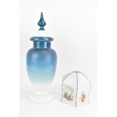 491 - A late 19th century opaline glass lidded vase, having a knopped finial, the ovoid body painted in bl... 