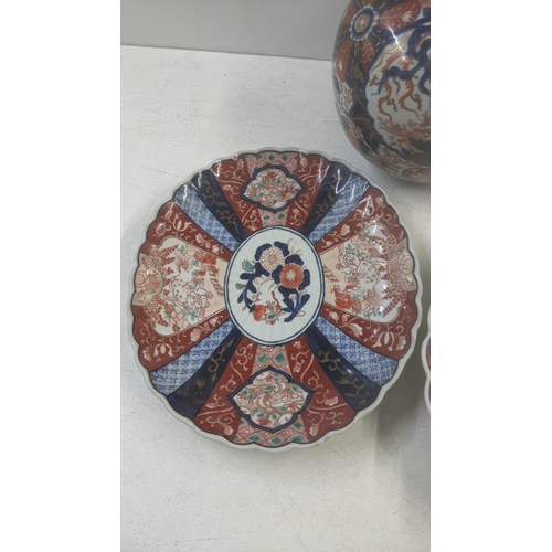 462 - A 19th century Japanese Imari bottle vase, 40cm h together with a 19th century Japanese charger and ... 