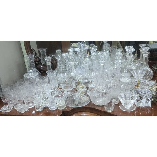 474 - A quantity of glassware to include a variety of crystal cut glass decanters, a pair of wine glasses ... 