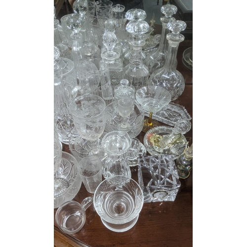 474 - A quantity of glassware to include a variety of crystal cut glass decanters, a pair of wine glasses ... 