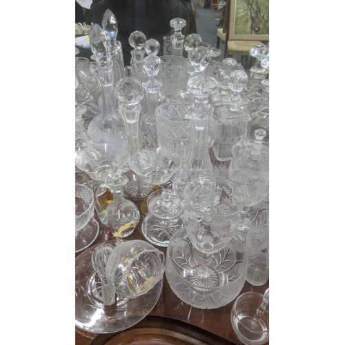 474 - A quantity of glassware to include a variety of crystal cut glass decanters, a pair of wine glasses ... 