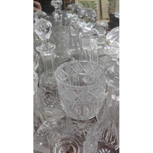 474 - A quantity of glassware to include a variety of crystal cut glass decanters, a pair of wine glasses ... 