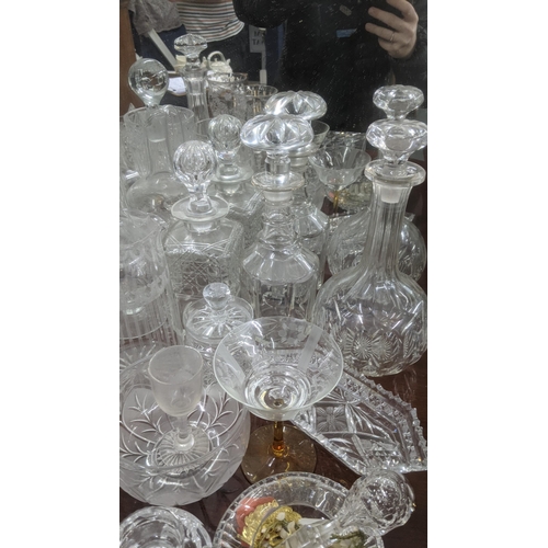 474 - A quantity of glassware to include a variety of crystal cut glass decanters, a pair of wine glasses ... 