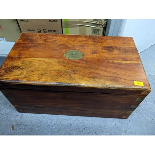 485 - A teak and brass bound chest with brass plaque to the lid having a French inscription 35.5cm x 72cm ... 