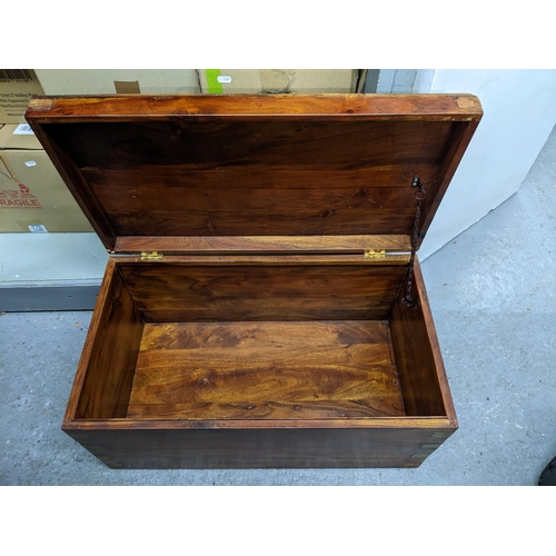 485 - A teak and brass bound chest with brass plaque to the lid having a French inscription 35.5cm x 72cm ... 