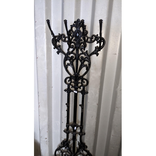 498 - A Victorian style cast iron black painted hallstand having a floral scroll design frame and drip tra... 