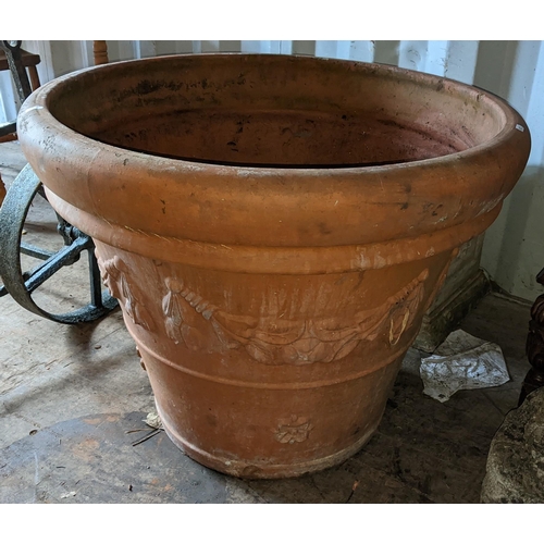 504 - Five terracotta garden planters to include a large planter of tapering form with cast floral swags, ... 